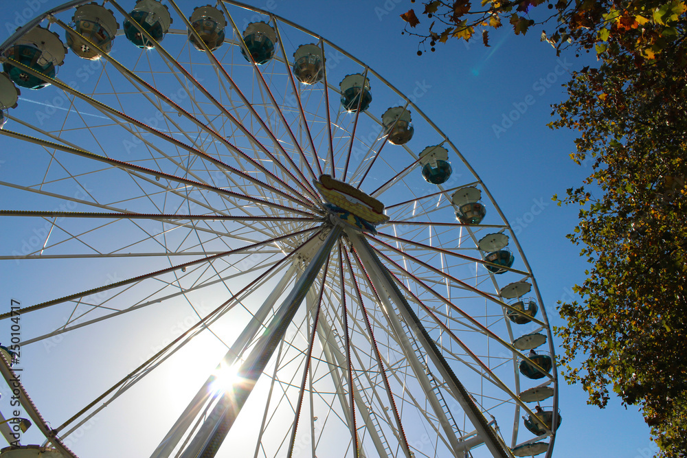 Ferris wheel on the background of the sunny sky. Ferris wheel on the background of the sunny sky.