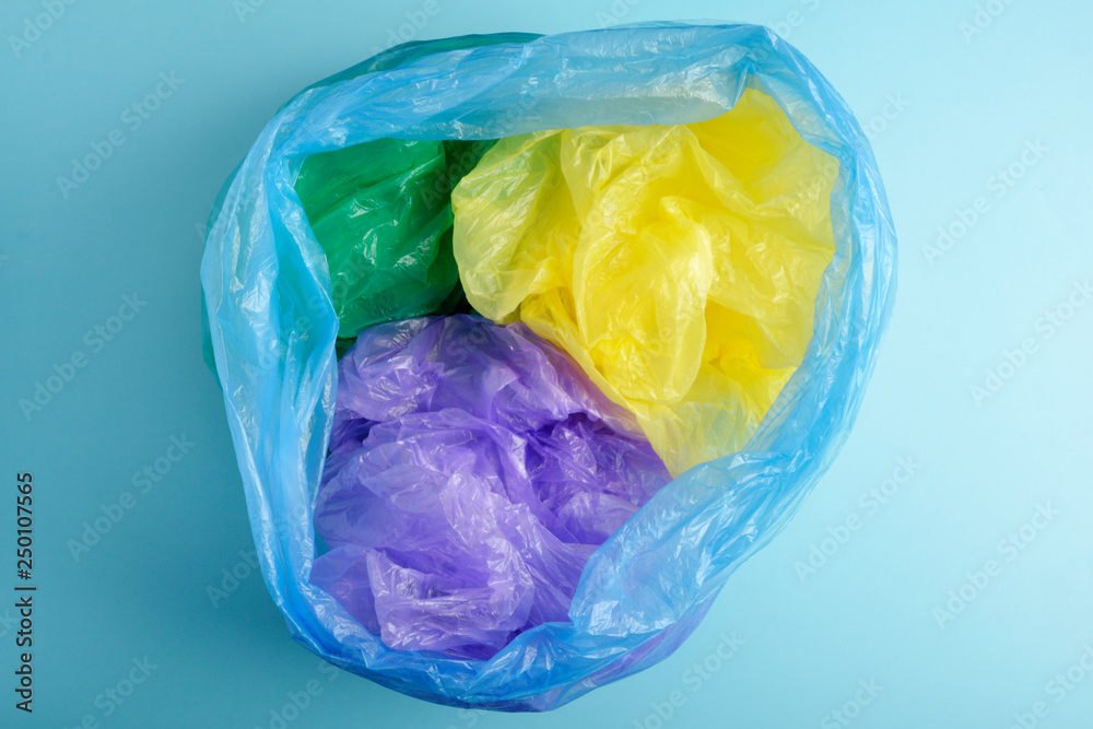 Fototapeta premium Plastic Bags isolated on blue background. Flat lay