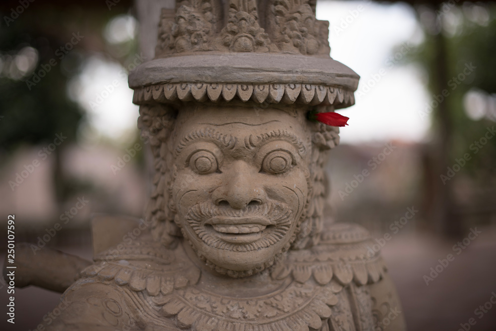 Face of a statue in royal Taman Ayun Temple in Mengwi, Badung, Bali, Indonesia 