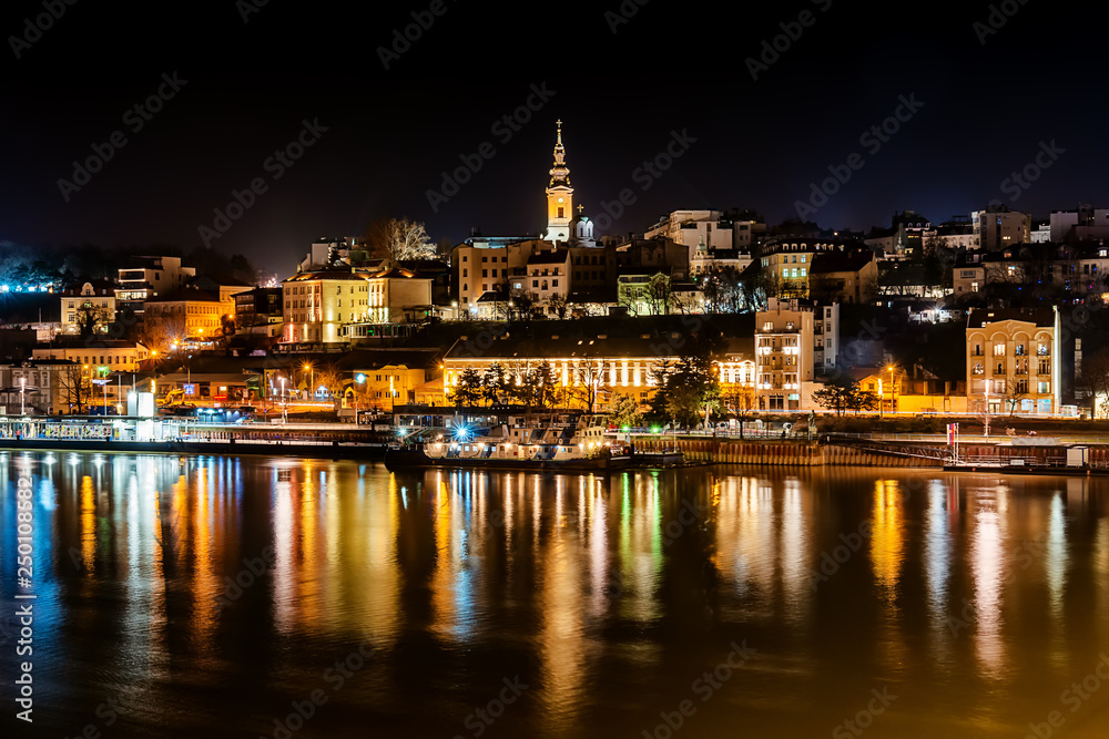 Belgrade, Serbia - February 10, 2019: Panorama of Belgrade with a view from Branko bridge at night with a reflection. View of Cathedral Church of St. Michael the Archangel (serbian: Saborna crkva).