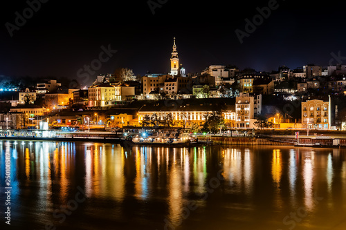 Belgrade, Serbia - February 10, 2019: Panorama of Belgrade with a view from Branko bridge at night with a reflection. View of Cathedral Church of St. Michael the Archangel (serbian: Saborna crkva).