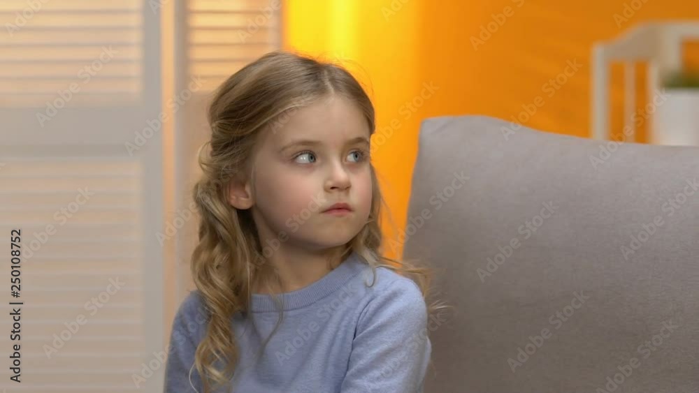 Sad preschool girl looking at indifferent babysitter, conflict with mom, offence Sad preschool girl looking at indifferent babysitter, conflict with mom, offence