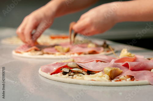 Hands preparing italian pizza