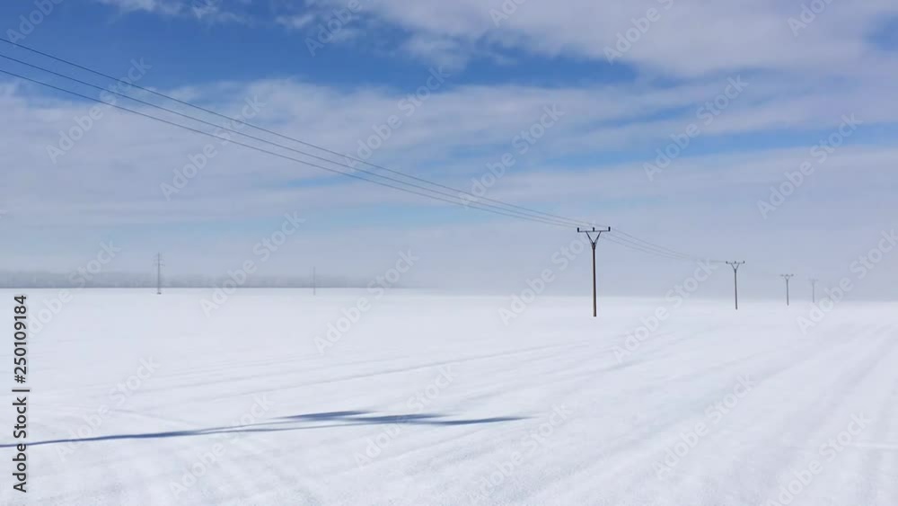 Winter landscape with power line columns a snow covered field. Winter landscape with power line columns a snow covered field.