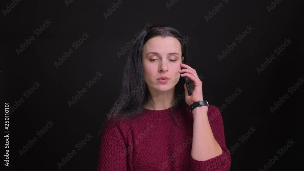 Closeup portrait of adult caucasian woman having a phone call getting angry and annoyed in front of the camera Closeup portrait of adult caucasian woman having a phone call getting angry and annoyed in front of the camera