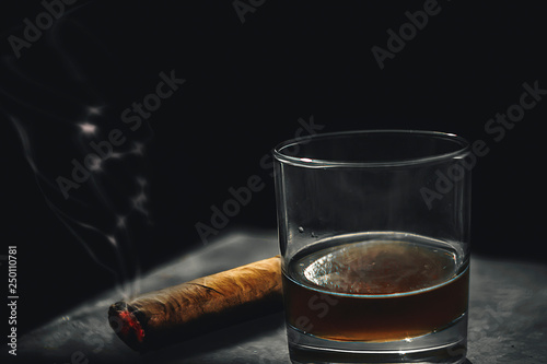 cigar and whiskey on wooden table