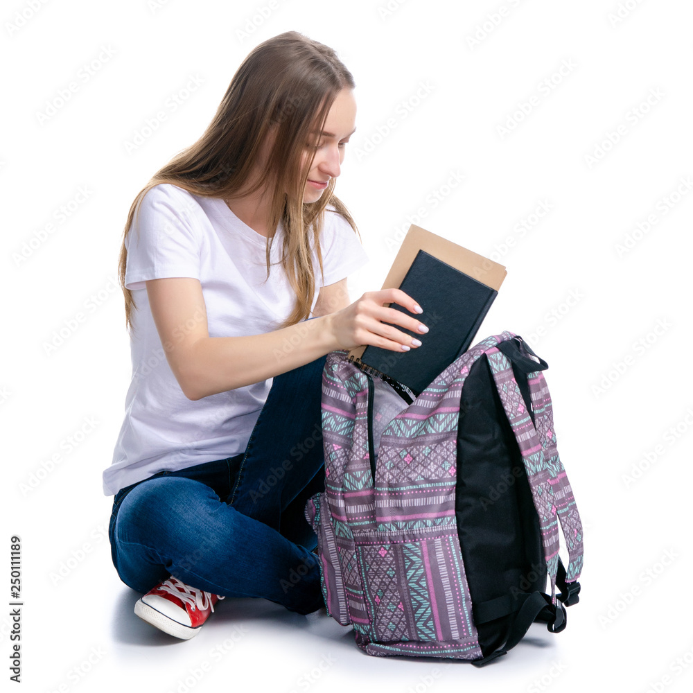 Woman sitting with backpack put notebook book on white background isolation Woman sitting with backpack put notebook book on white background isolation
