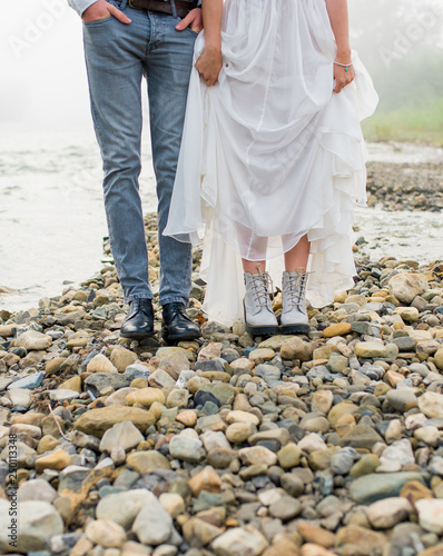 Beautiful bride and groom. Just merried. wedding couple.close-up wedding shoes. bride and groom in mountains, beautiful nature, landscape, fog, stream