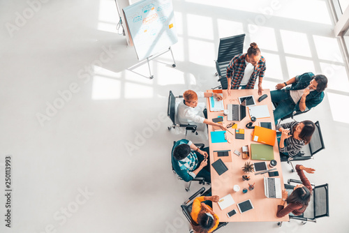 Multiethnic diverse group of business coworkers in team meeting discussion, top view modern office with copy space. Partnership professional teamwork, startup company, or project brainstorm concept photo