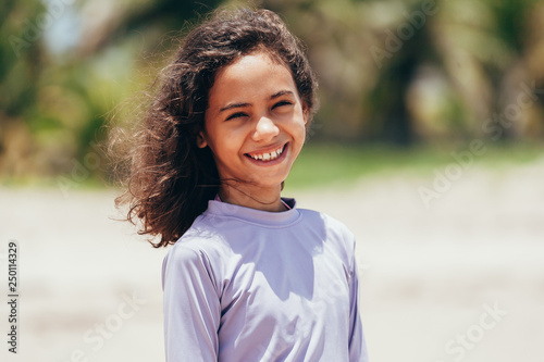 Portrait of little girl wearing sun protective clothing on the beach
