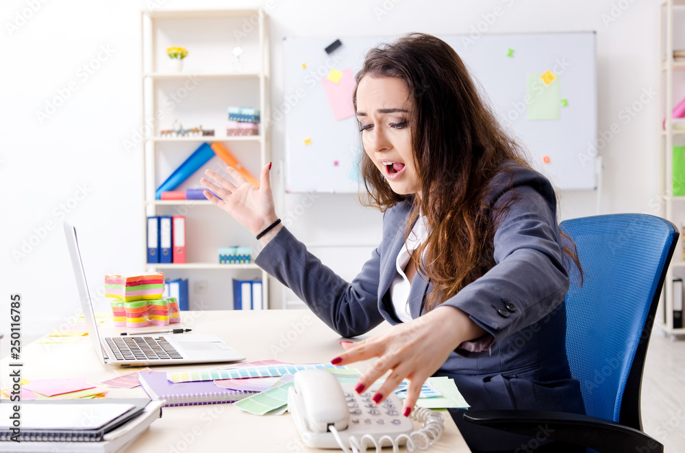 Young female designer working in the office Young female designer working in the office
