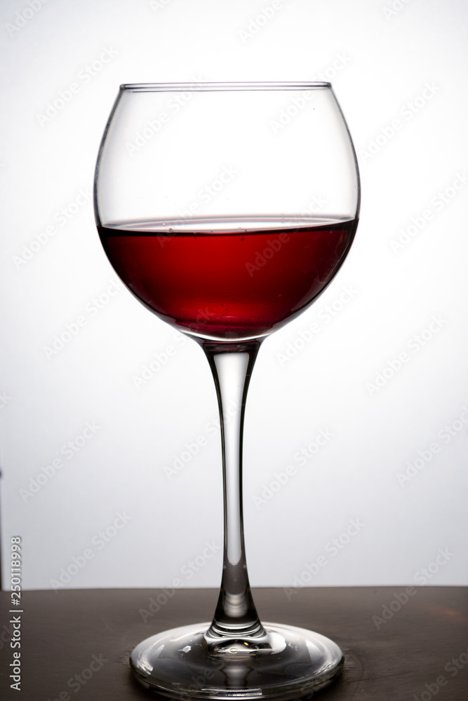 Wine glass with red wine on white background