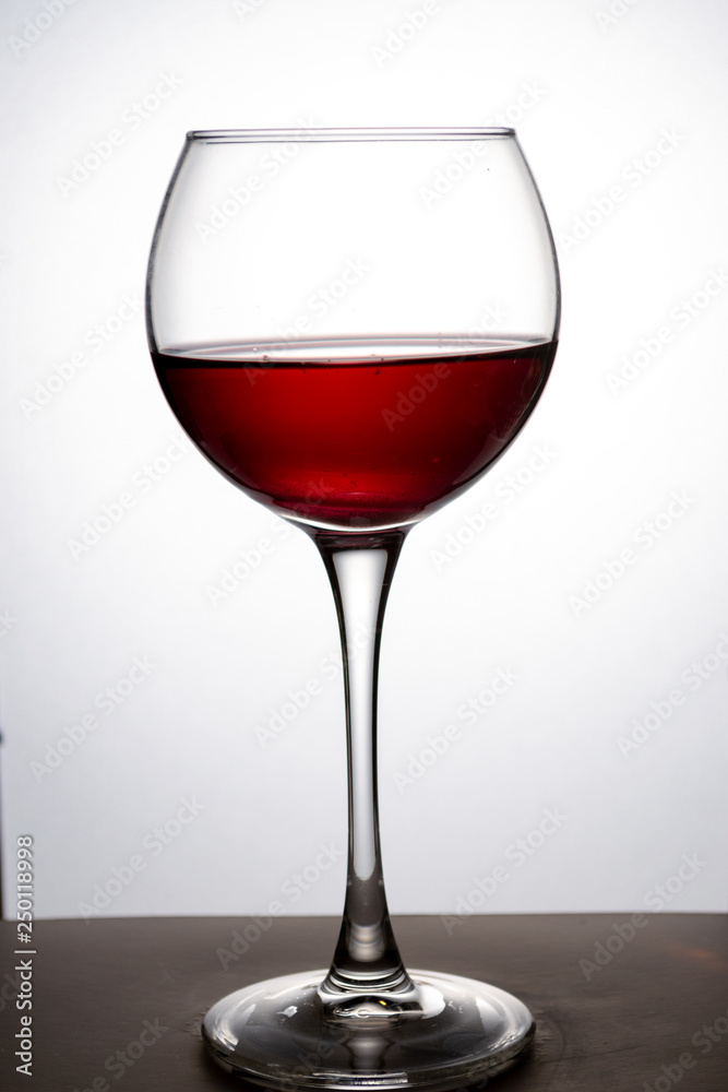 Wine glass with red wine on white background Wine glass with red wine on white background