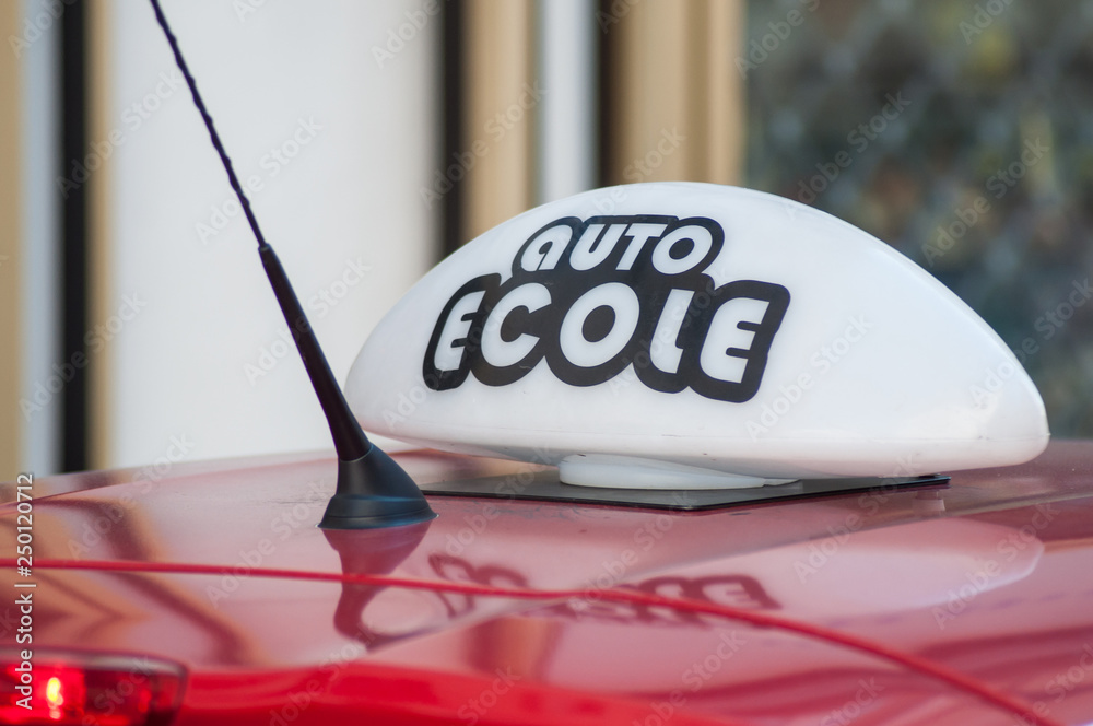 closeup of french driving school panel on the car roof , text in french closeup of french driving school panel on the car roof , text in french