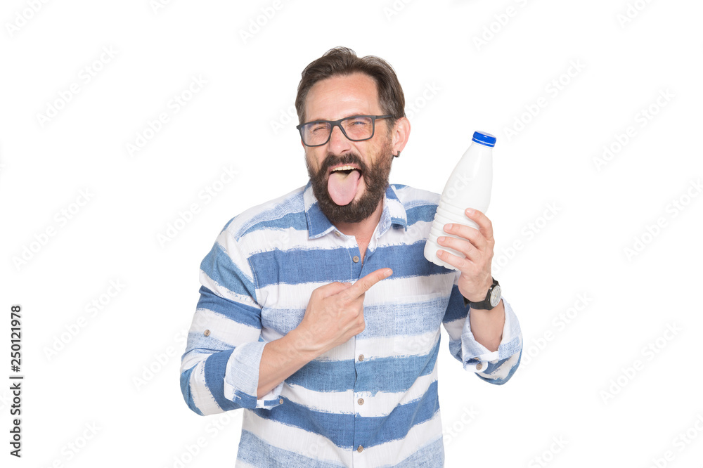 Waist up of bearded man in spectacles expressing disgust to milk Waist up of bearded man in spectacles expressing disgust to milk