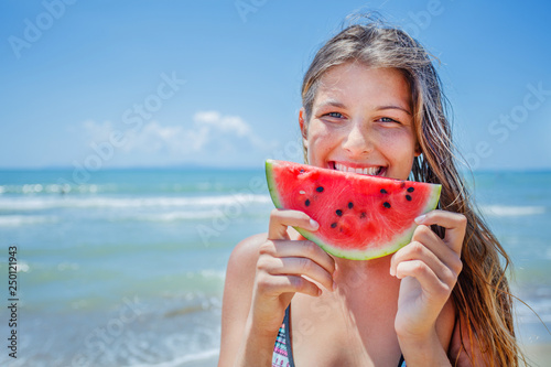 Portrait of beautiful girl with watermelon on the beach.