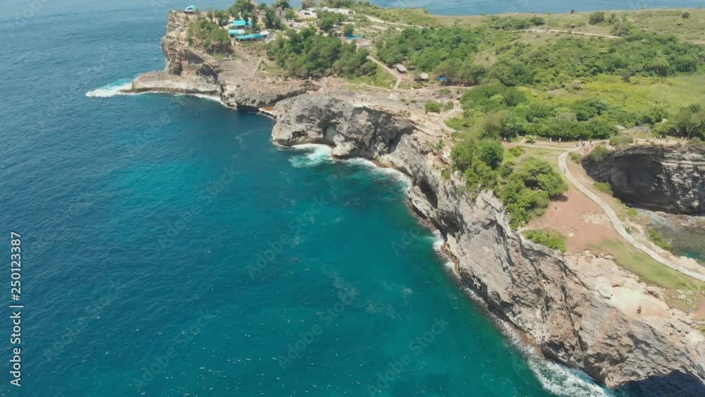 Broken Beach In Nusa Penida, Indonesia - Overhead View Of Rocky Coast And Coves. Aerial view. Broken Beach In Nusa Penida, Indonesia - Overhead View Of Rocky Coast And Coves. Aerial view.