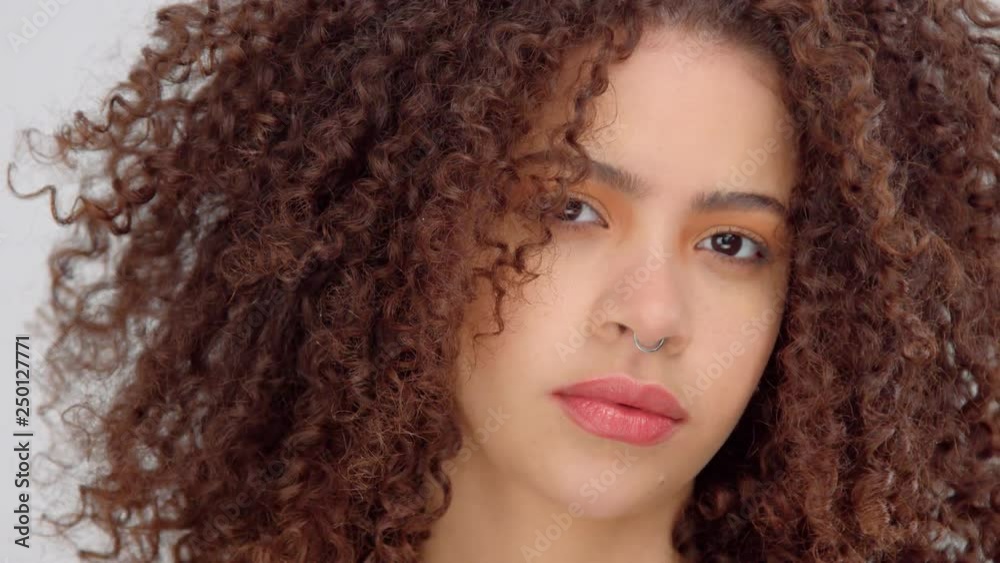 closeup panned video portrait of mixed race model with freckles watching