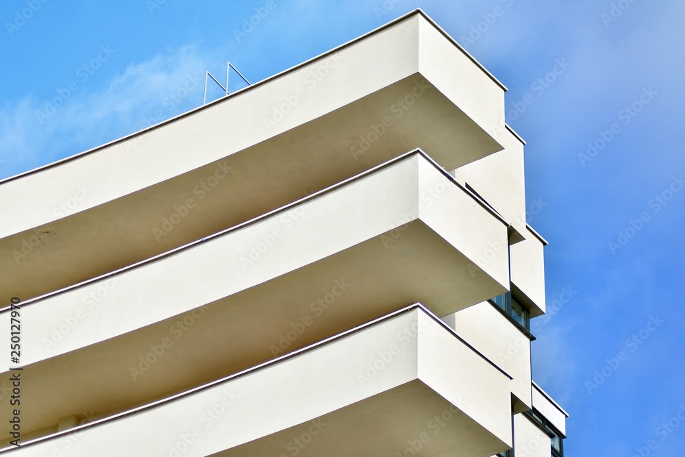 Modern white building with balcony on a blue sky Modern white building with balcony on a blue sky
