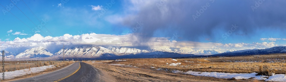 Winter Panoramic view of Snow capped Wasatch Front Rocky Mountains, Great Salt Lake Valley and Cloudscape from the Bacchus Highway. Utah, USA. Winter Panoramic view of Snow capped Wasatch Front Rocky Mountains, Great Salt Lake Valley and Cloudscape from the Bacchus Highway. Utah, USA.