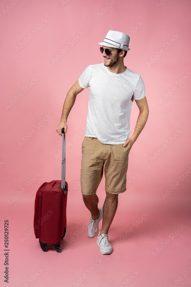 Man traveler with suitcase, passport and ticket on color background. Man traveler with suitcase, passport and ticket on color background.