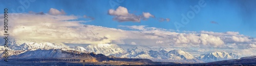 Winter Panoramic view of Snow capped Wasatch Front Rocky Mountains, Great Salt Lake Valley and Cloudscape from the Bacchus Highway. Utah, USA. © Jeremy