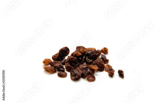 Dried raisins on a white, isolated background. Concept of eating dried grapes, snack eating fruit. Eating dried fruit.