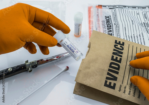  Crime scene for cutting weapon, Judicial police takes blood samples in evidence bag, conceptual image photo