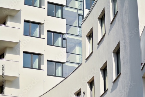 Modern white building with balcony on a blue sky © Grand Warszawski