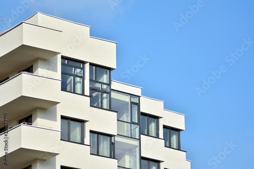 Modern white building with balcony on a blue sky