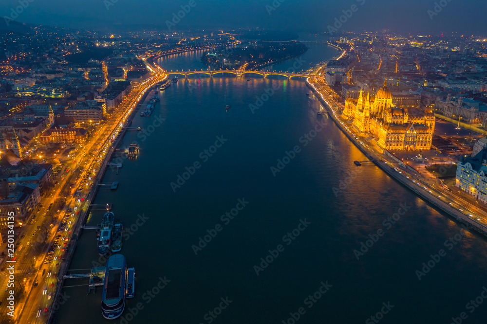 Budapest, Hungary - Aerial skyline view of Budapest by night with illuminated Parliament, Margaret Bridge and riverside of River Danube