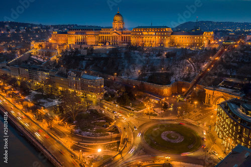 Budapest, Hungary - Aerial view of Clark Adam Square with illuminated Buda Castle Royal Palace and Buda Tunnel at blue hour on a winter evening
