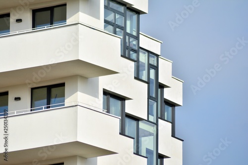 Modern white building with balcony on a blue sky