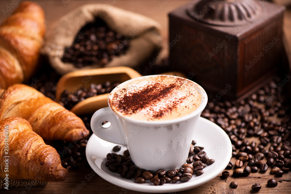  coffee cup close-up over dark roasted coffee beans
