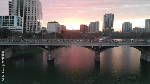 Aerial View of Thousands of People Running in the Austin Marathon across the Congress Street Bridge at Sunrise