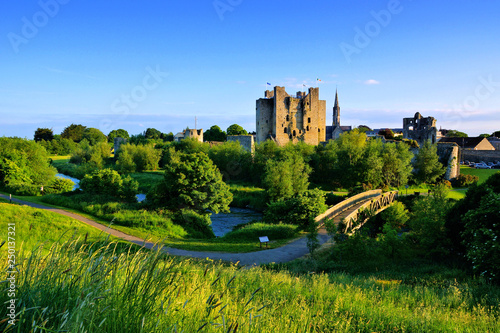 Historic Trim Castle with foot bridge. Late day light, County Meath, Ireland photo