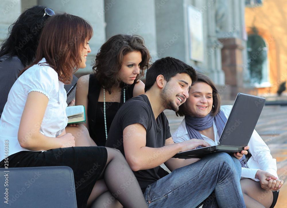 group of fellow students with books and laptop group of fellow students with books and laptop