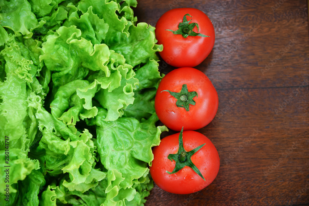 Tomatoes and lettuce on wooden background Tomatoes and lettuce on wooden background
