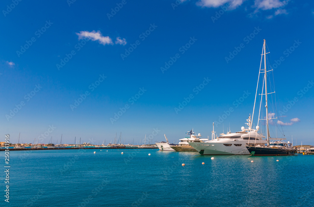 Yacht and Sailboat on blue sky and water in marina
