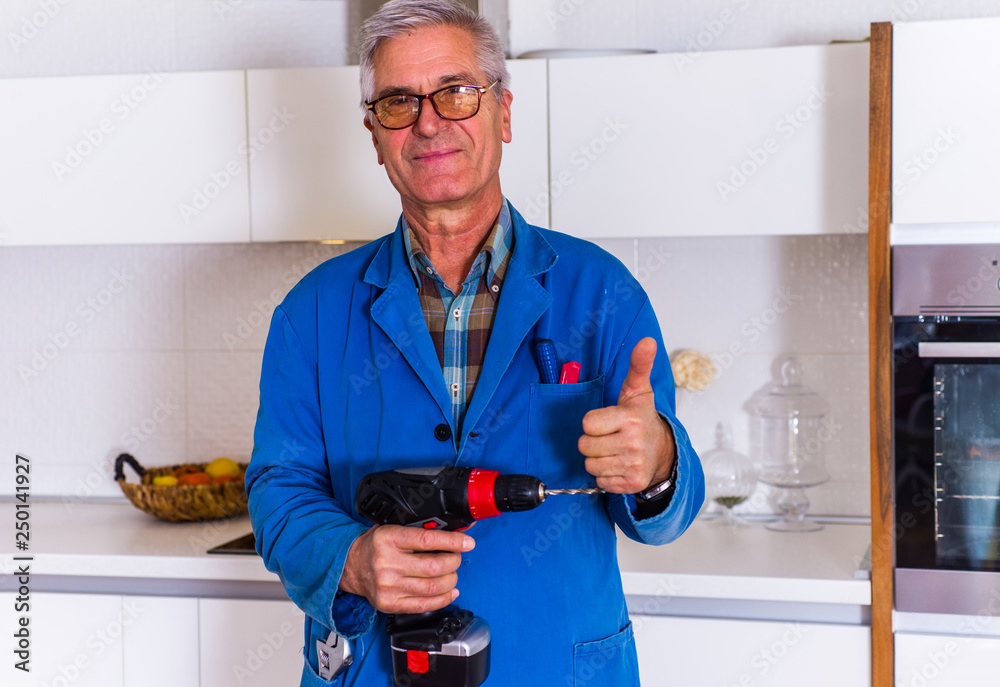 Workman holding dril and shows thumbs up Workman holding dril and shows thumbs up