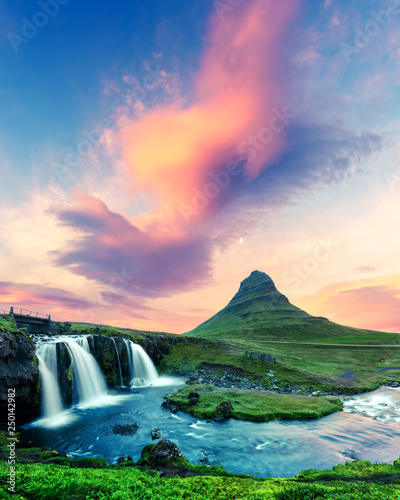 Fototapeta Naklejka Na Ścianę i Meble -  Colorful sunrise on Kirkjufellsfoss waterfall. Amazing morning scene near Kirkjufell volkano, Iceland