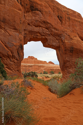 An overcast shot of the Pine Tree Arch in the Devils Garden in Arches National Park, Utah.