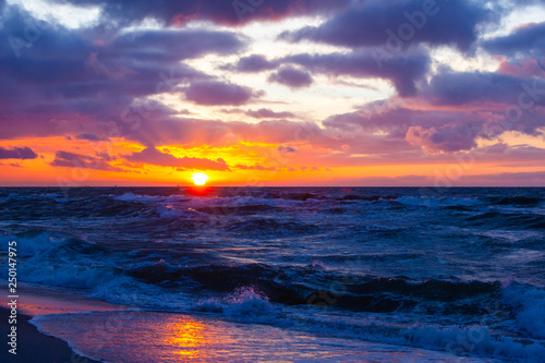 picturesque seascape with colorful clouds and bright sunshine during sunset © Sergey