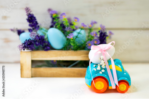 Easter cars with an egg on a white background, the concept of the approaching easter