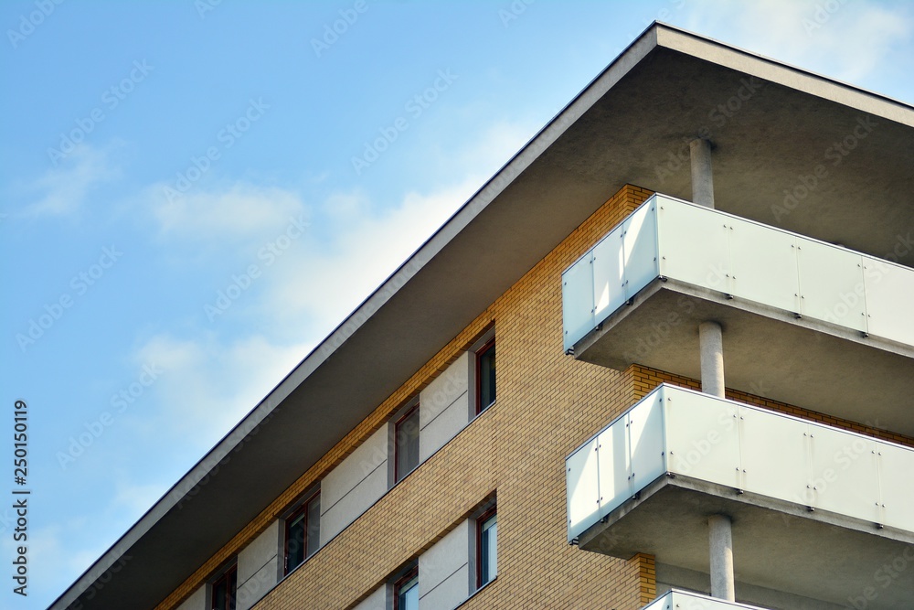 Modern white building with balcony on a blue sky