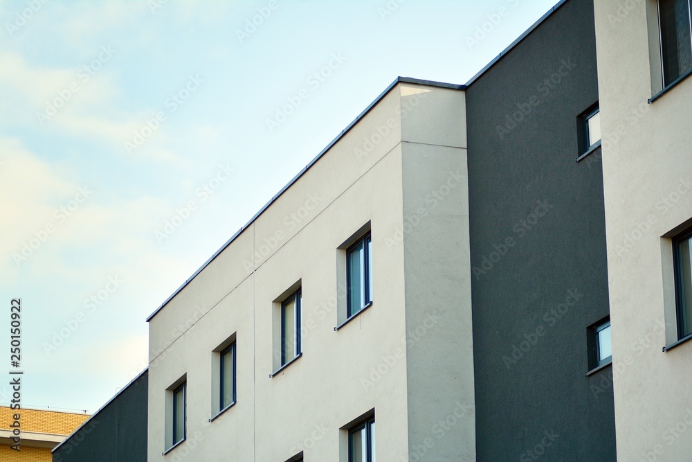 Modern white building with balcony on a blue sky