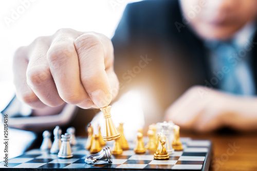 business man playing chess. He planing strategy for business.