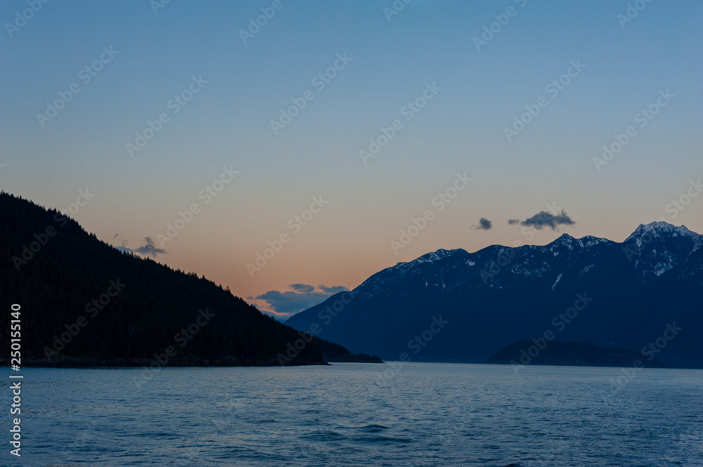 View of Cypress Provincial Park mountains and Bowen Island at dusk from Georgia Strait, British Columbia, Canada
