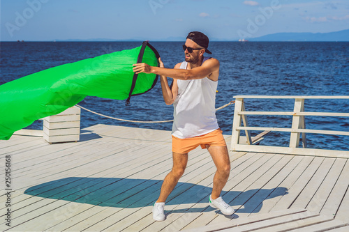 Man tries to inflate an air sofa. lamzac photo