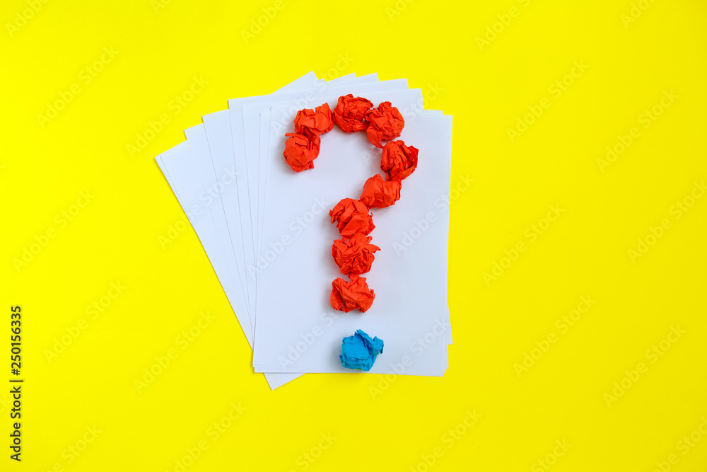 Question mark lined with crumpled paper on colorful background top view copy space